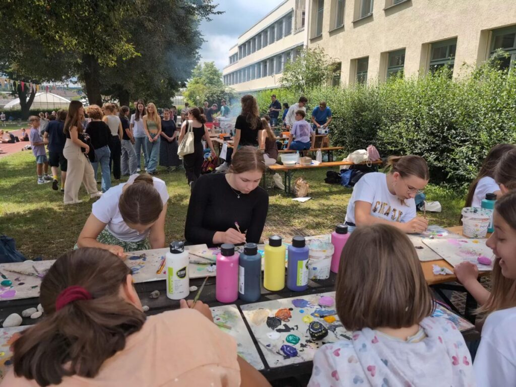 Schulveranstaltung im Freien mit malenden Kindern